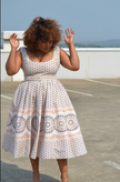 Beige midi dress with circular medallion border print, square neckline, gathered skirt