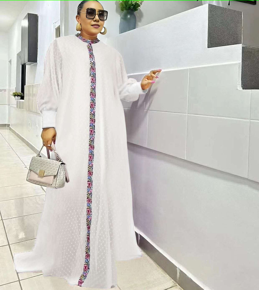 White maxi dress with long sleeves and floral placket trim