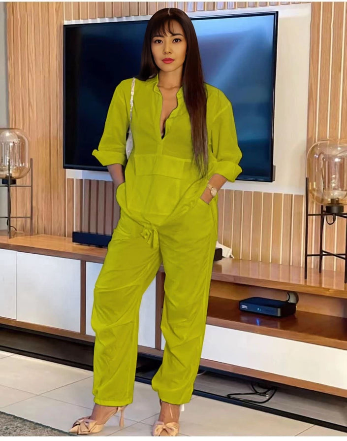 Lime green solid color jumpsuit with long sleeves, V-neck, and drawstring waist