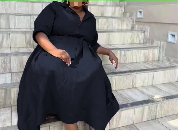 Black belted midi dress with pointed collar, button front, and three-quarter sleeves