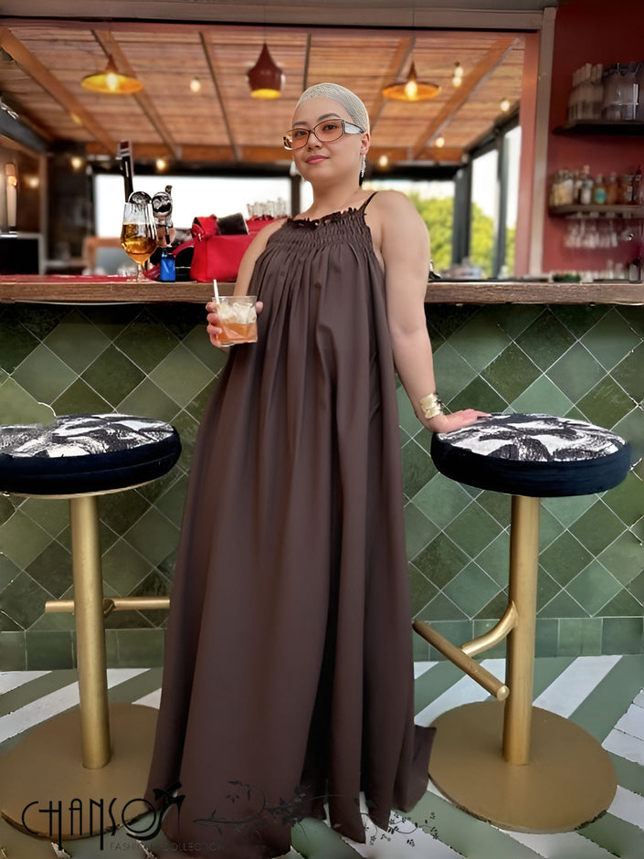 Dark sleeveless maxi dress with gathered neckline and draped skirt