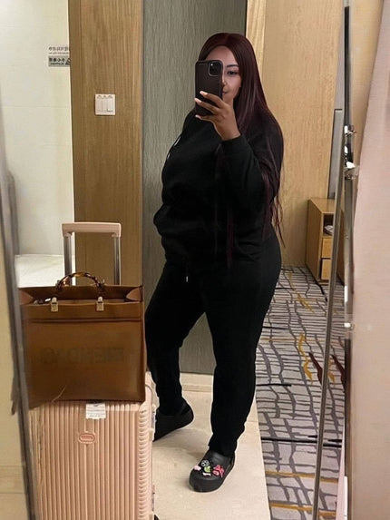 Black hoodie and jogger pants set worn, front view with drawstring waist