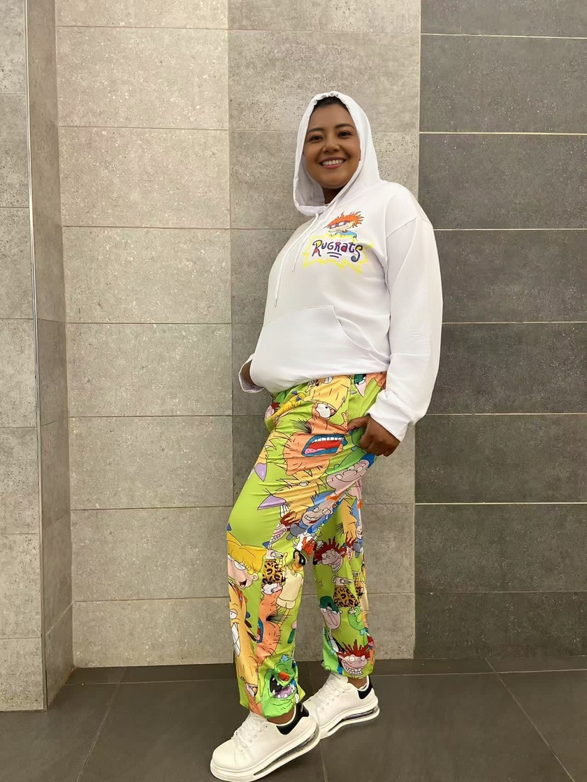 Cartoon hoodie and pants twin set, white hooded top with colorful chest logo; green cartoon joggers