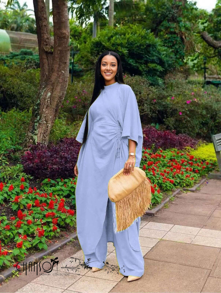 Gathered wide-leg pantsuit in light blue with draped side tie and wide sleeves