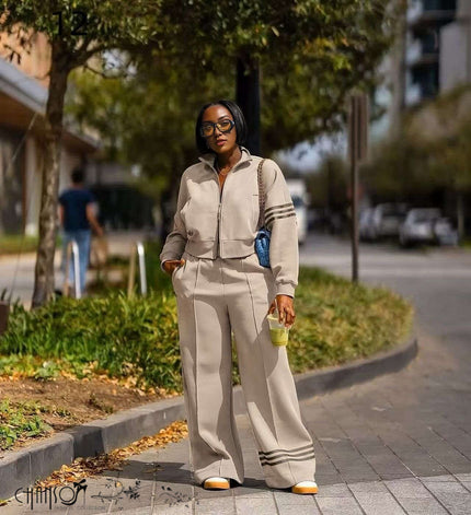 Nude zip-front jacket with striped cuffs and wide-leg pants, matching set