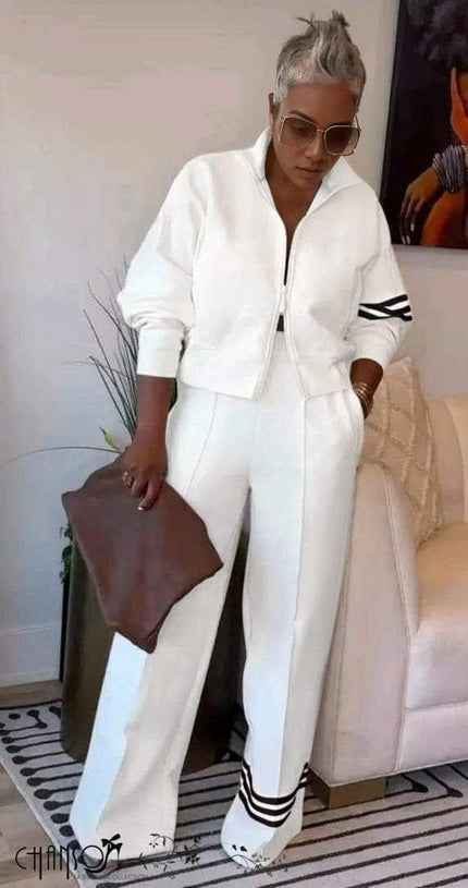 White zip jacket and wide-leg stripe pants with black trim cuffs and hem bands