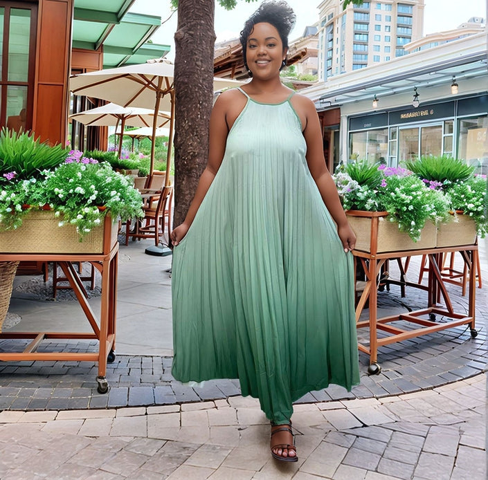 Pleated maxi dress with spaghetti straps, mint-green flowy A-line skirt and gathered bodice.