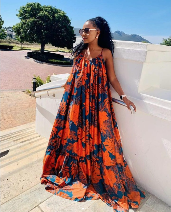Plus size maxi dress with sleeveless floral print, orange and blue, ruffled hem