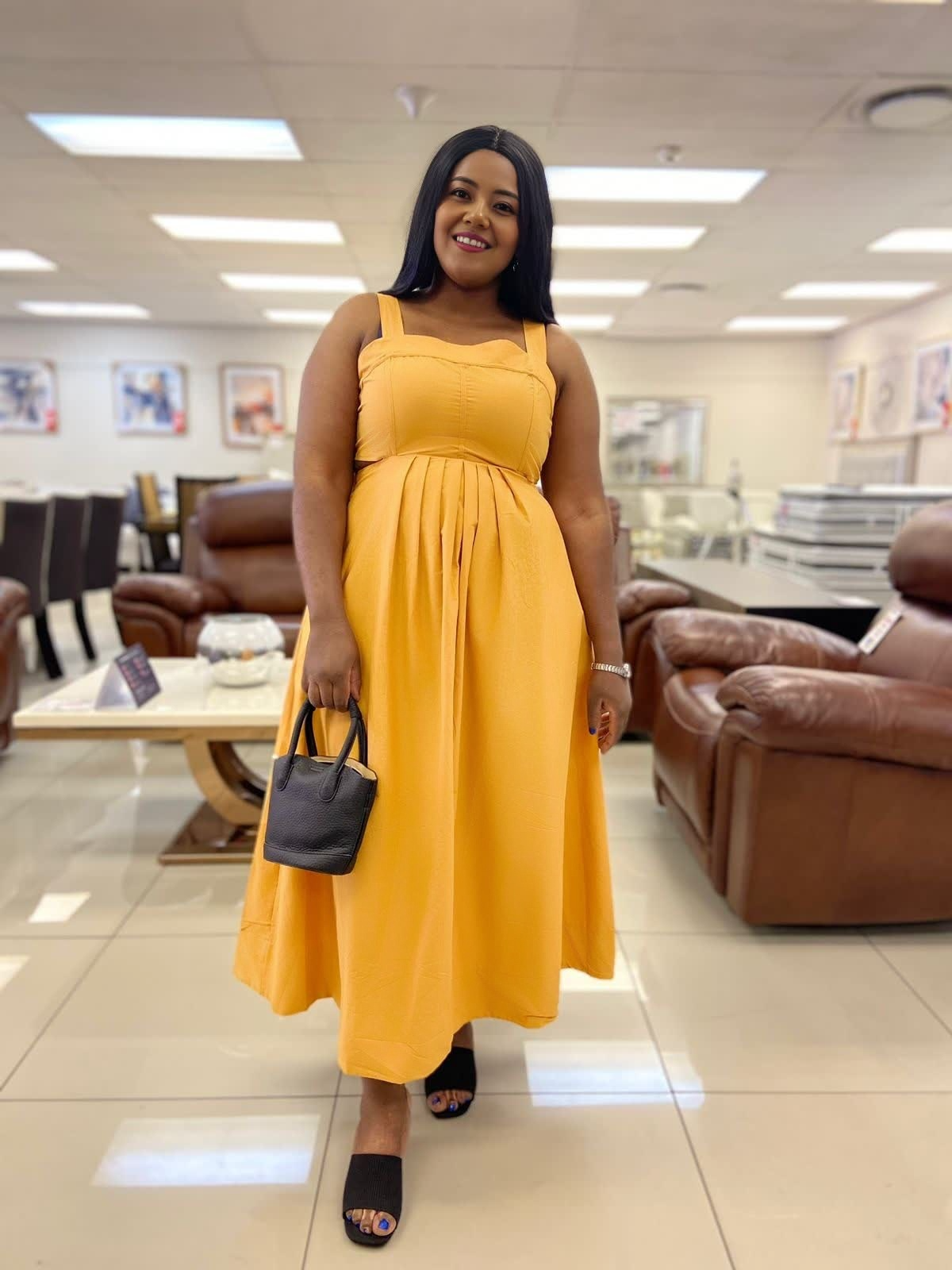 Mustard yellow pleated sleeveless midi dress with square neckline and high waist