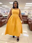 Mustard yellow pleated sleeveless midi dress with high waist and softly gathered bodice