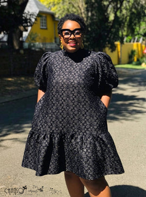 Black lace mini dress with puff sleeves and patterned lace texture