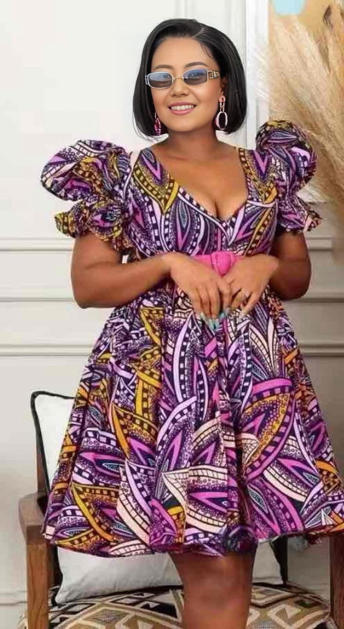 Purple printed puff-sleeve dress with pink and yellow geometric pattern, V-neck bodice