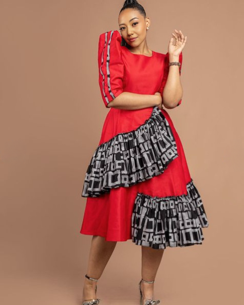 Tiered midi dress with puff sleeves, red bodice and black patterned tiered skirt