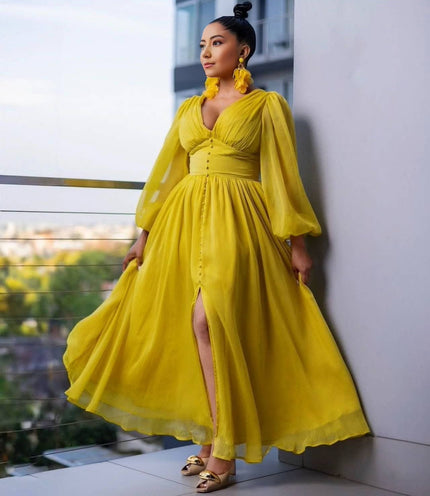Yellow maxi evening dress with puff sleeves, V-neck bodice, and front slit