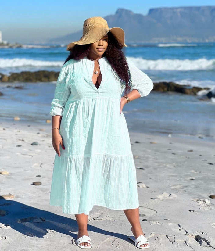 Light turquoise tiered maxi dress with V-neck and three-quarter sleeves