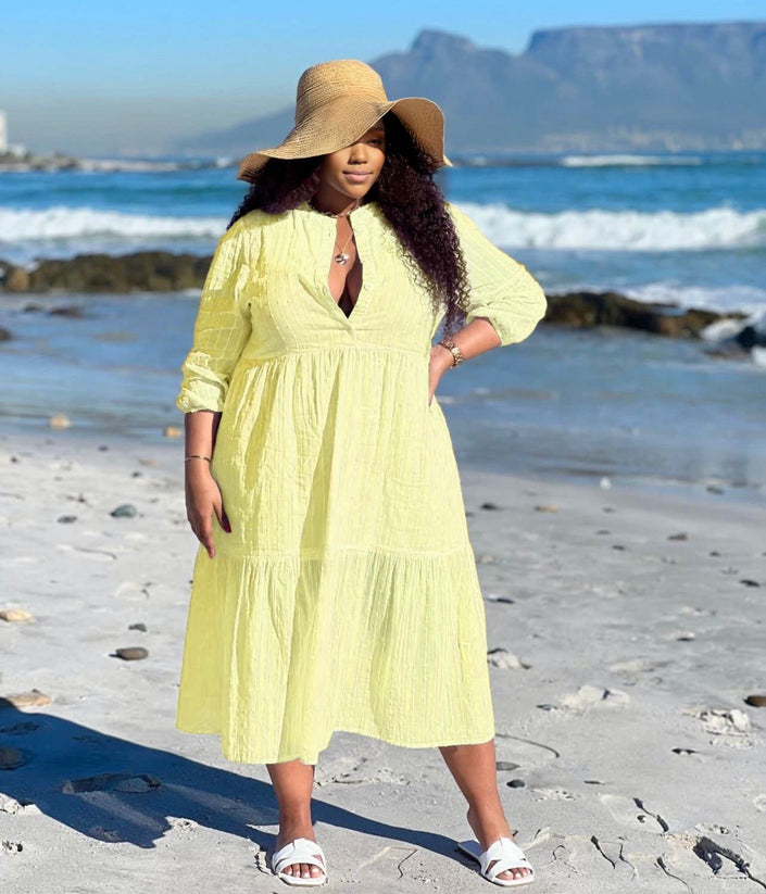 Light yellow tiered maxi dress with V-neck and three-quarter sleeves