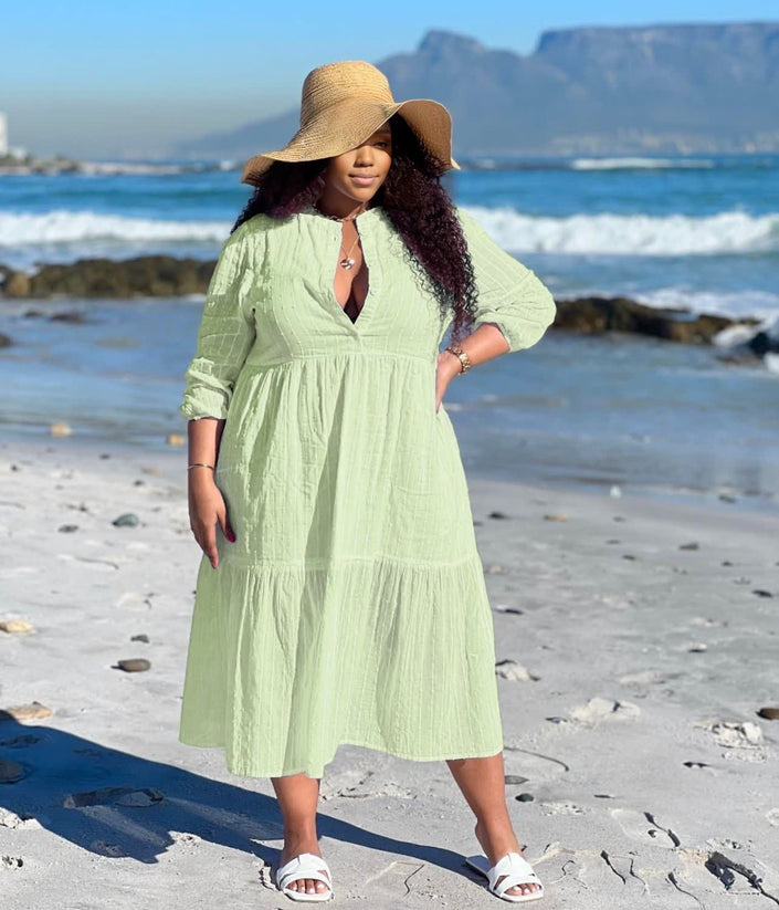 Light green tiered maxi dress with V-neck and three-quarter sleeves