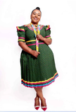 Green puff-sleeve midi dress with rainbow collar, yoke, and hem trim