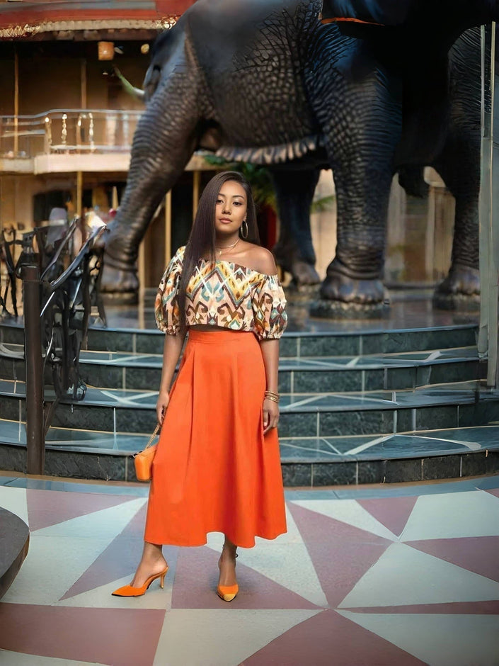 Off-shoulder geometric midi dress with orange A-line skirt