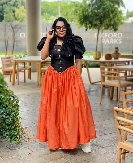 Puff sleeve maxi dress with black button bodice and pleated A-line orange skirt