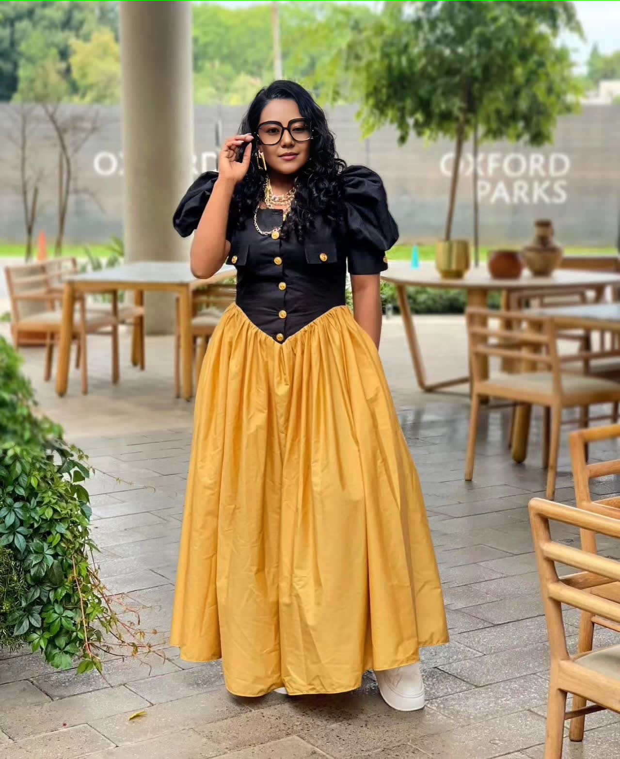 Puff sleeve maxi dress with black button bodice and pleated A-line yellow skirt