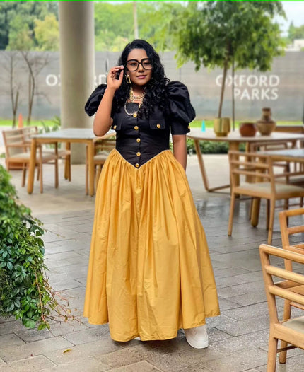 Puff sleeve maxi dress with black button bodice and pleated A-line yellow skirt