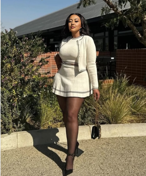 Cream knit cropped jacket and mini skirt set with striped trim at hem and cuffs