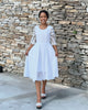 White lace midi dress with textured fit-and-flare bodice and 3/4 lace sleeves