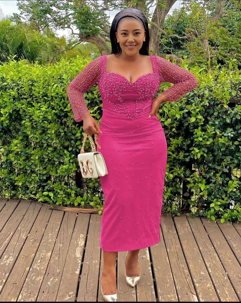 Sequin sheath midi dress in hot pink, V-neck, long sleeves, fitted silhouette.
