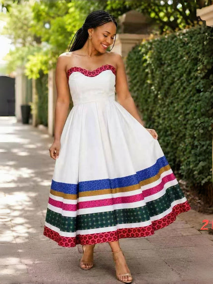 White strapless midi dress with colorful printed tiered hem and full skirt