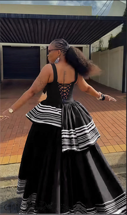 Black backless sleeveless maxi dress with geometric stripe layered ruffle hem
