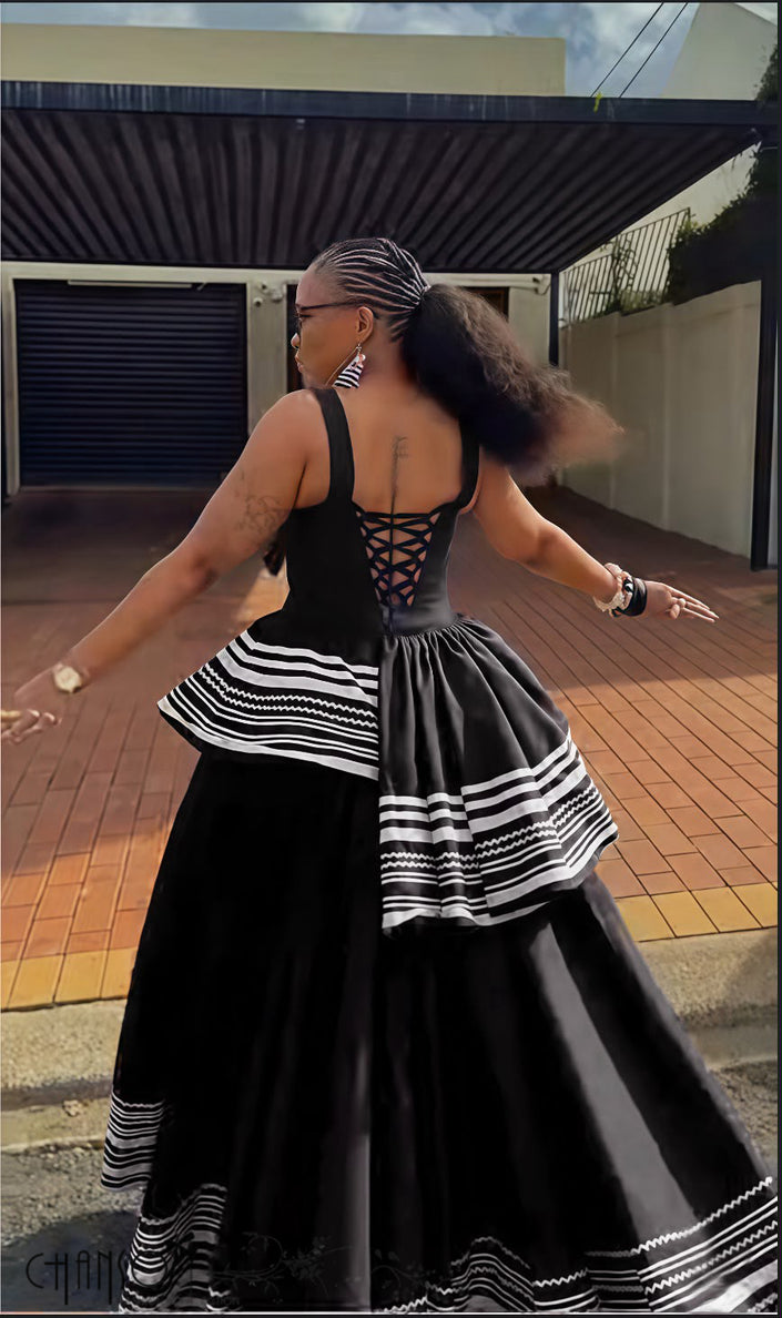 Black backless sleeveless maxi dress with geometric stripe layered ruffle hem