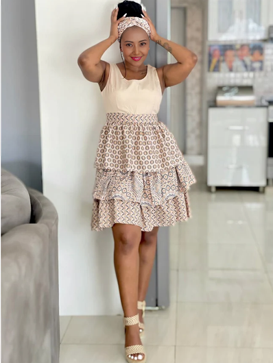 Sleeveless mini dress with circular pattern tiered ruffle skirt, cream