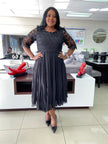 Black lace midi dress with textured bodice, short lace sleeves, and fit-and-flare skirt