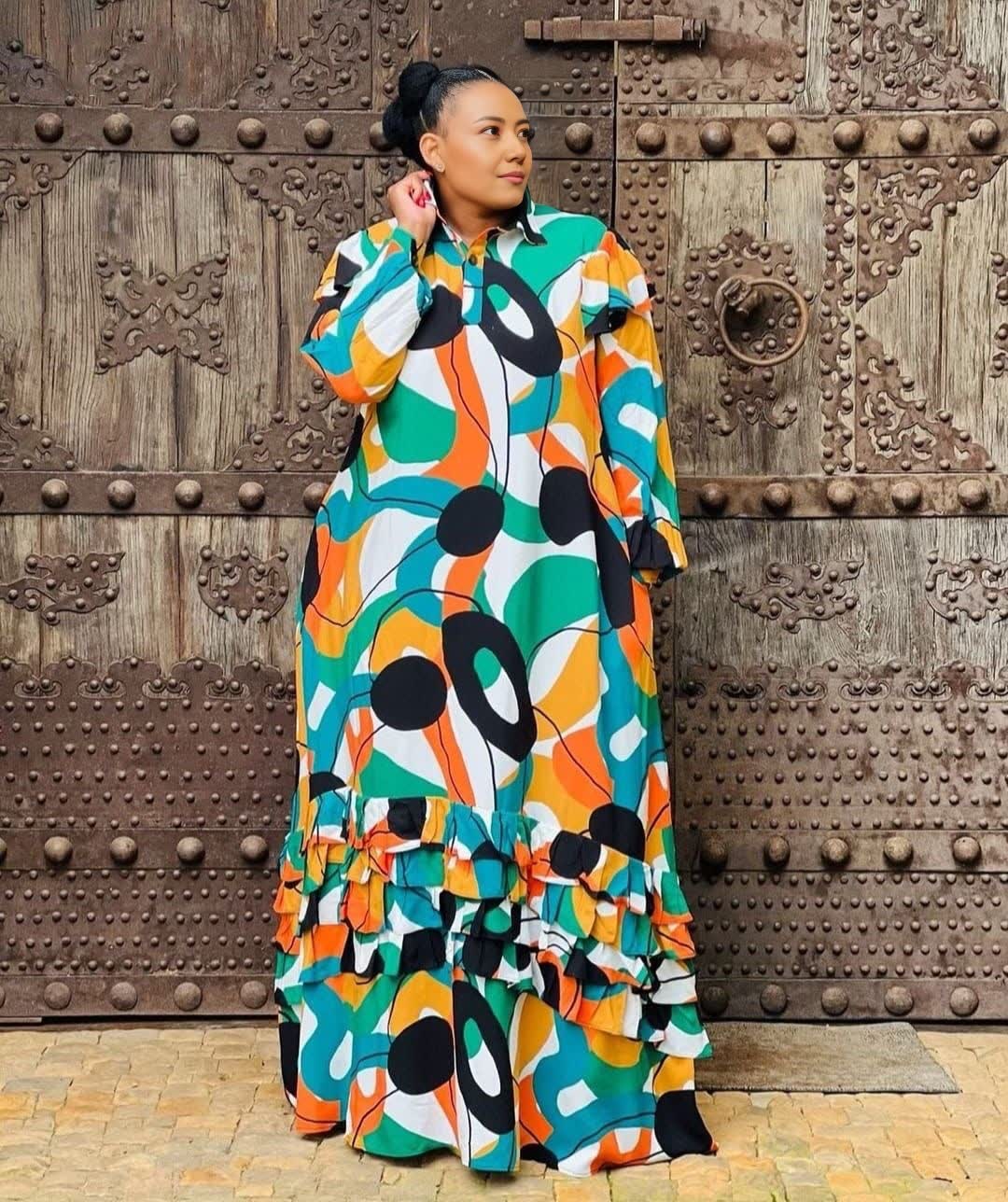 Plus size abstract maxi dress with colorful geometric print and ruffled hem
