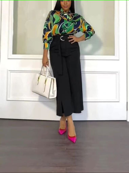 Printed blouse with abstract pattern and black straight trousers