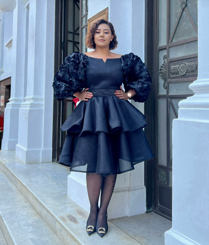 Black puff-sleeve layered dress with ruffled sleeves and V-neck