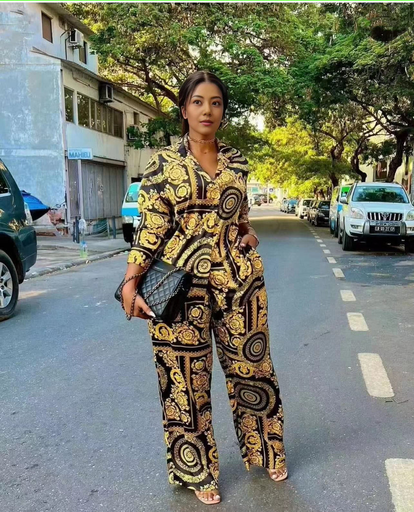 Printed lounge set: long-sleeve top and matching patterned trousers, dark with gold accents