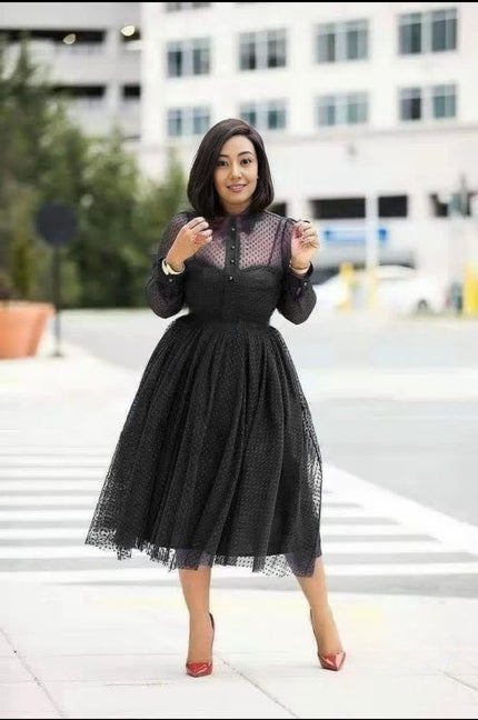 Black polka dot sheer midi dress with flared skirt and long sleeves