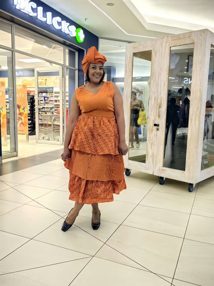 Orange layered midi dress with tiered ruffles and V-neck, African print