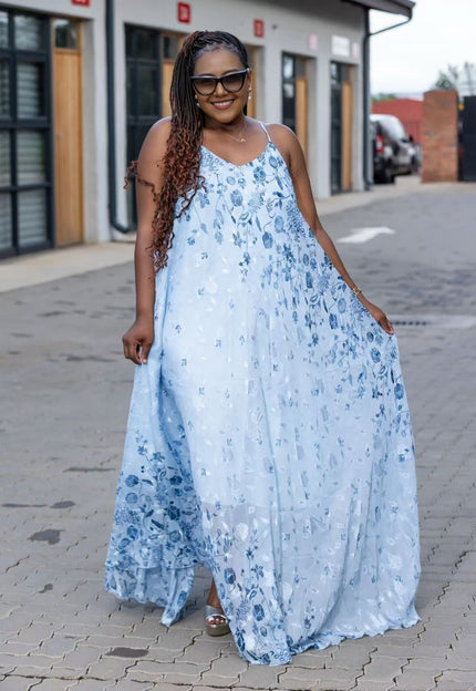 Light blue floral maxi dress with spaghetti straps, sleeveless, flowing skirt