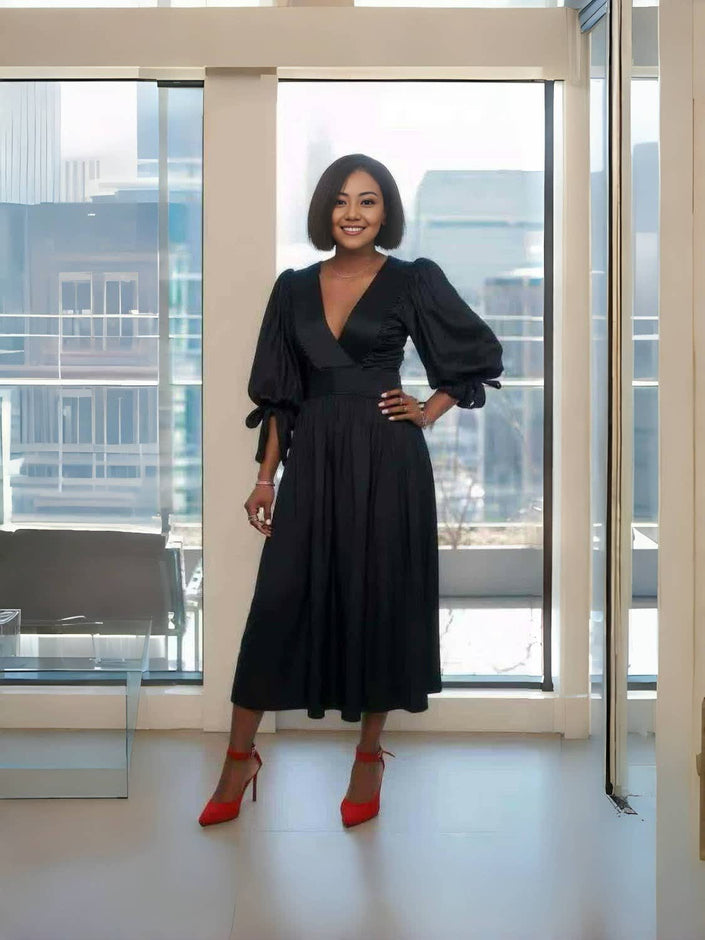 Black midi dress with V-neck, puff sleeves, and gathered waist