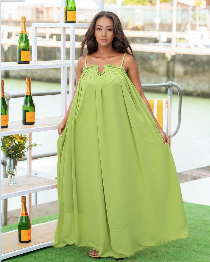 Green maxi dress with adjustable spaghetti straps, smocked bust detail, full skirt.