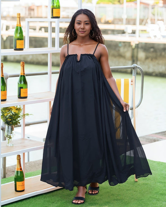 Black maxi dress with adjustable spaghetti straps, gathered bodice, flowy full skirt.