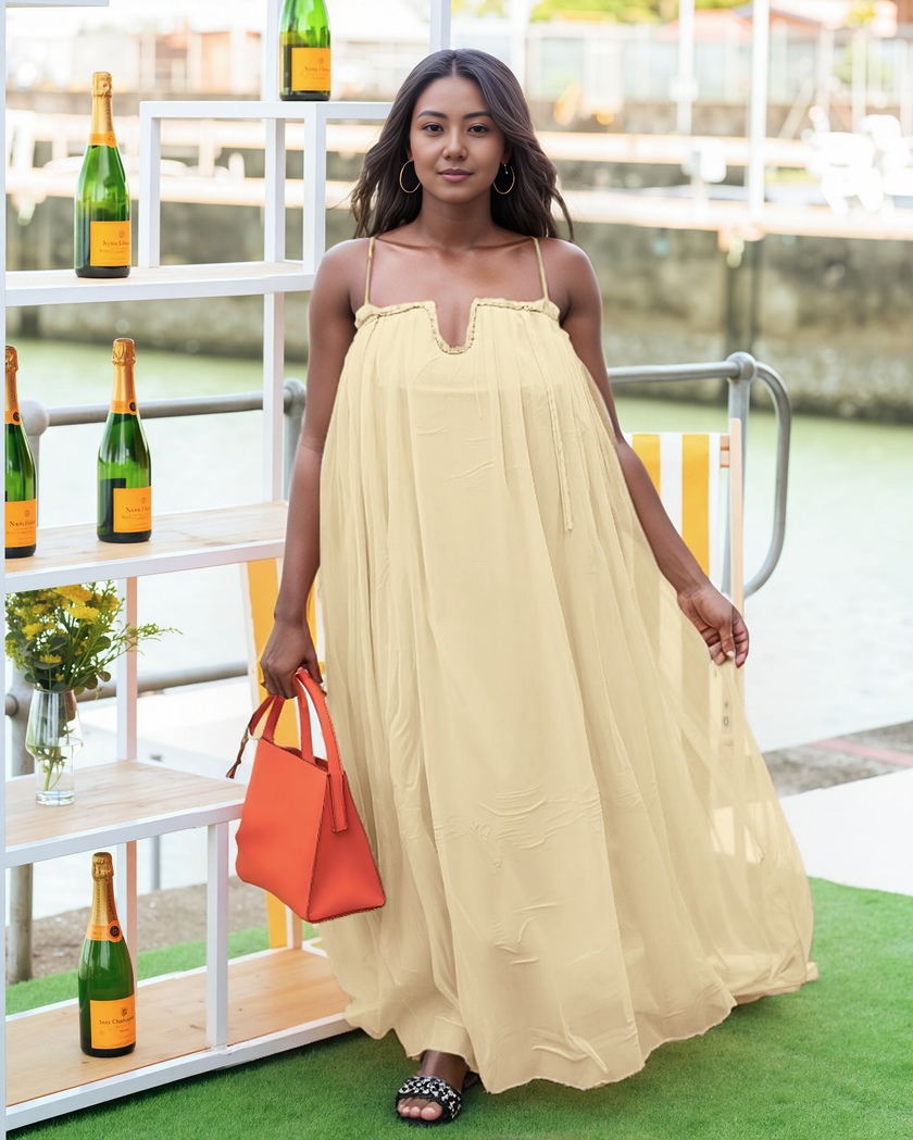 Flowy beige maxi dress with adjustable spaghetti straps and gathered neckline