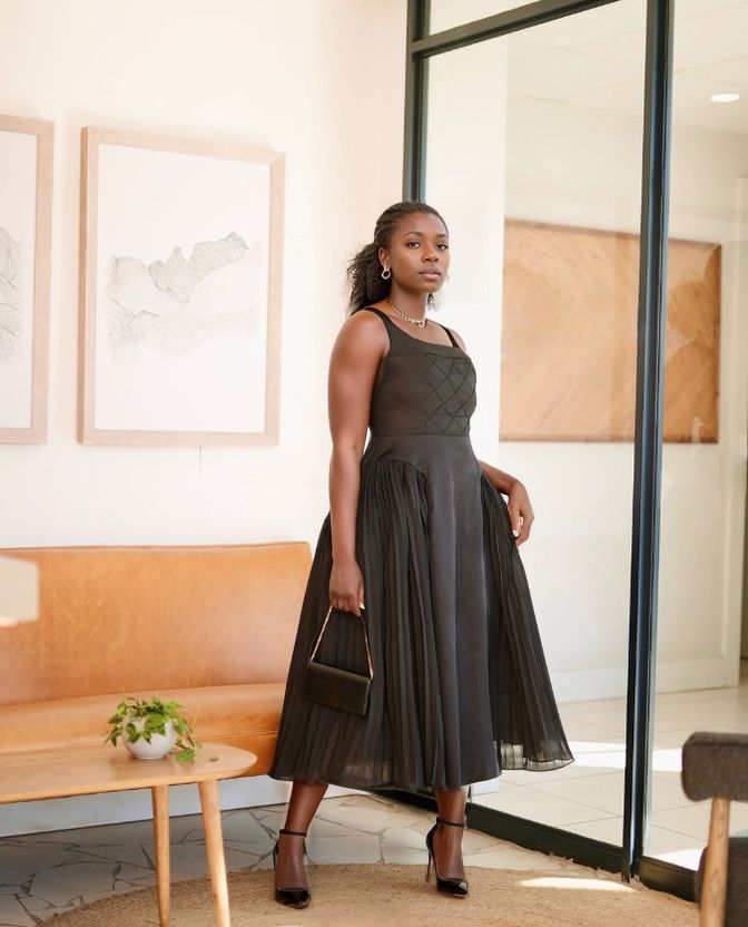 Black sleeveless square-neck midi dress with quilted diamond bodice and pleated skirt