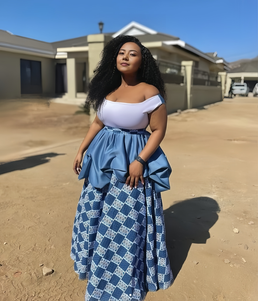 Off-shoulder light-blue top with white geometric blue midi skirt, gathered waist