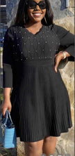 Knit midi dress with pleated skirt and bead-studded V neckline, dark knit