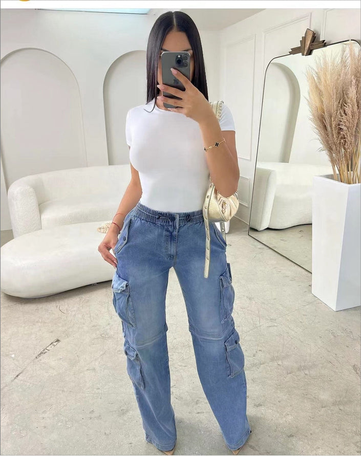 Women’s blue cargo jeans with stretch waist and multiple front pockets, wide leg