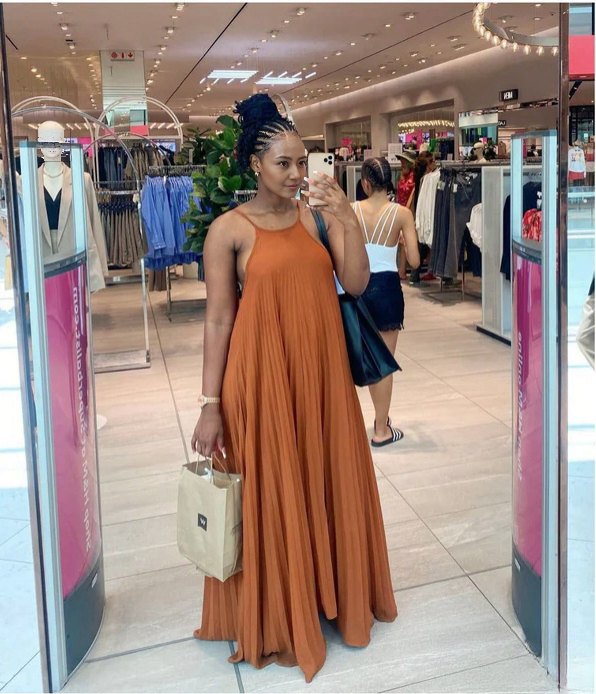 Rust-orange pleated spaghetti-strap maxi dress with a sleeveless scoop neckline
